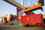 Freight container, with the Chinese flag painted on, being loaded onto a large ship in a commercial dock