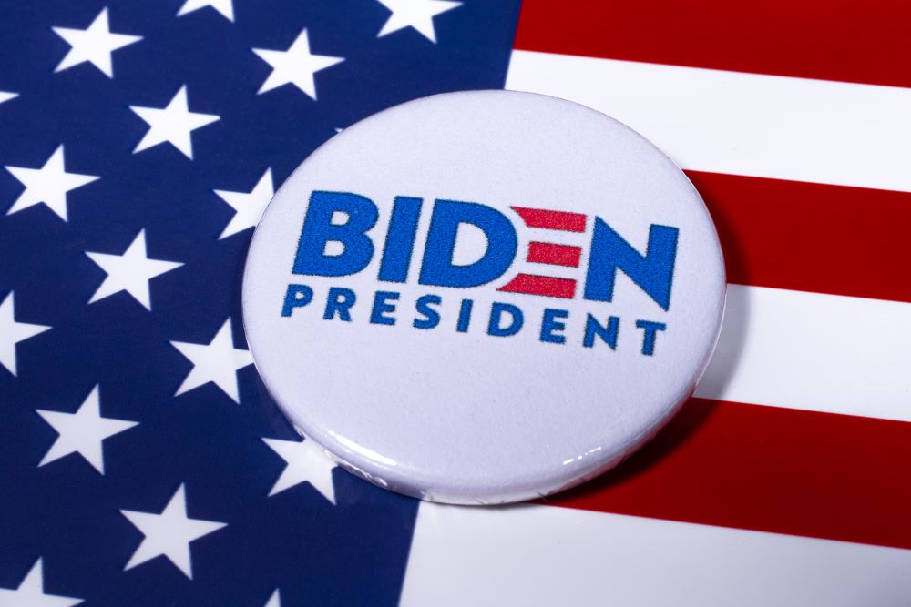 President Biden campaign button over US flag