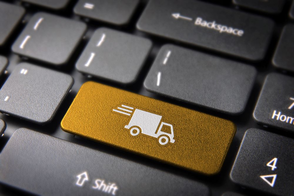 Black keyboard with amber symbol of moving lorry in place of 'enter' sign