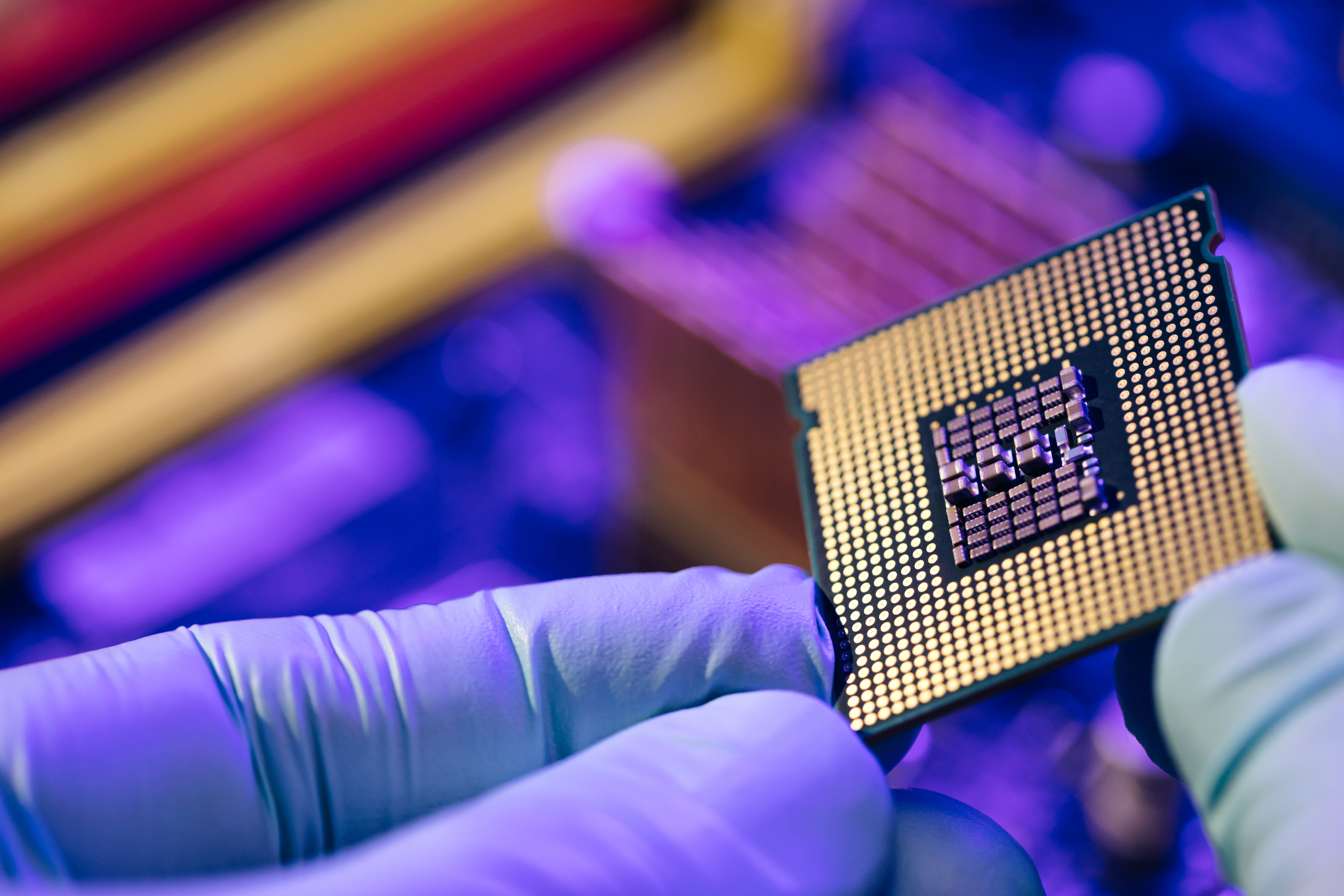 Semiconductor being handled by gloved scientists