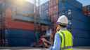 Worker In Front Of Freight Crates