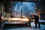 Man in factory cuts sheet of steel, sparks fly
